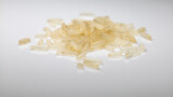 close up of heap of white, parboiled rice on white background 