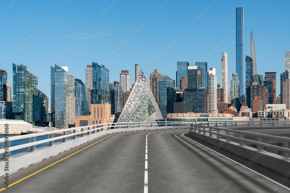Empty urban asphalt road exterior with city buildings background. New modern highway concrete construction. Concept of way to success. Transportation logistic industry fast delivery. New York. USA. Empty urban asphalt road exterior with city buildings background. New modern highway concrete construction. Concept of way to success. Transportation logistic industry fast delivery. New York. USA.