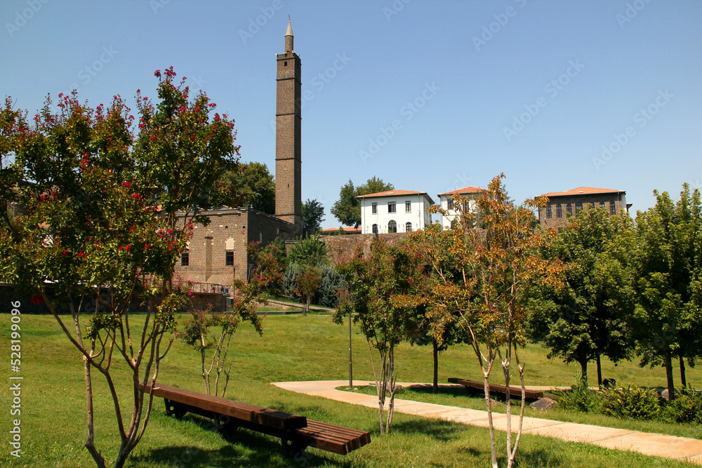 View of the park and the Hazrat Suleiman Mosque with a square minaret in the historical part of the city of Diyarbakir, in the Southeast Anatolia region, Turkey