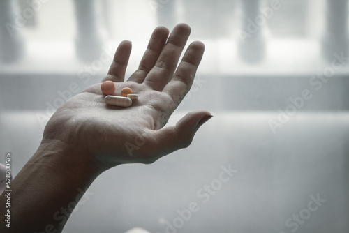 Smooth Focus In the woman's hand, there was an antidepressant pill in her hand because she had to regularly take antidepressant pills due to her paranoia and inability to control her feelings.