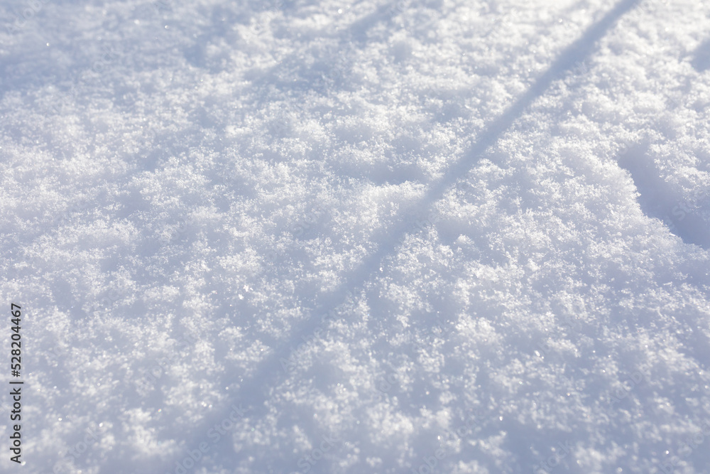 Obraz premium texture of fresh fluffy snow with shadows. Background of fresh snow texture. Top view of the natural pure snow. copy space.