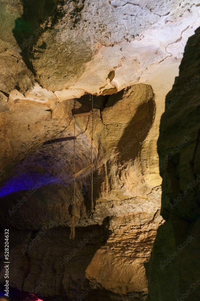Magic and mystical lighting inside Cave of the Winds stalactite cavity hollow attraction near Colorado Springs in mountains with rock formations light shadow stone beauty nature landscape