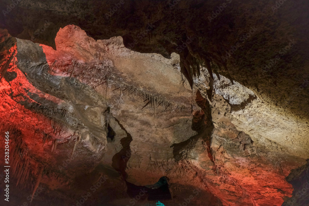 Magic and mystical lighting inside Cave of the Winds stalactite cavity hollow attraction near Colorado Springs in mountains with rock formations light shadow stone beauty nature landscape