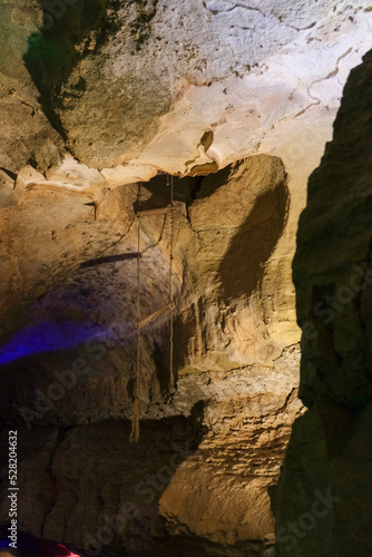 Magic and mystical lighting inside Cave of the Winds stalactite cavity hollow attraction near Colorado Springs in mountains with rock formations light shadow stone beauty nature landscape