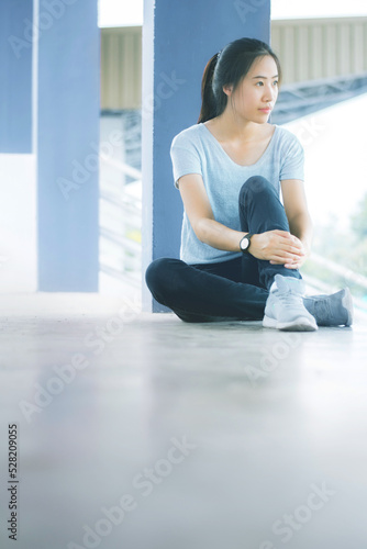 Negative emotions. Full length of young Asian woman sitting with dull or thoughtful face expression, feeling upset or tired, having problem or depression © Rattanapon