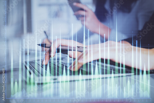 Multi exposure of woman hands typing on computer and financial graph hologram drawing. Stock market analysis concept.