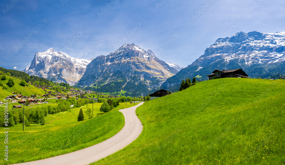 amazing landscape of alpine village Grindelwald with Eiger mountain during spring sunny day in Switzerland