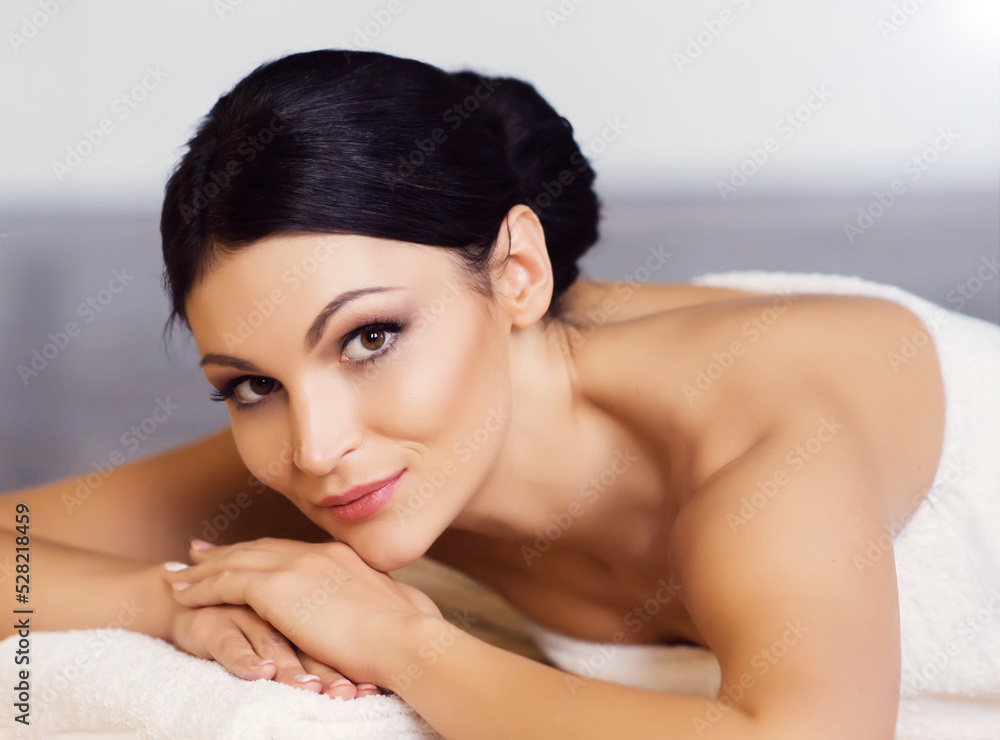 Young, healthy and beautiful woman gets massage therapy in the spa salon. Healthy lifestyle and body care concept. Young, healthy and beautiful woman gets massage therapy in the spa salon. Healthy lifestyle and body care concept.