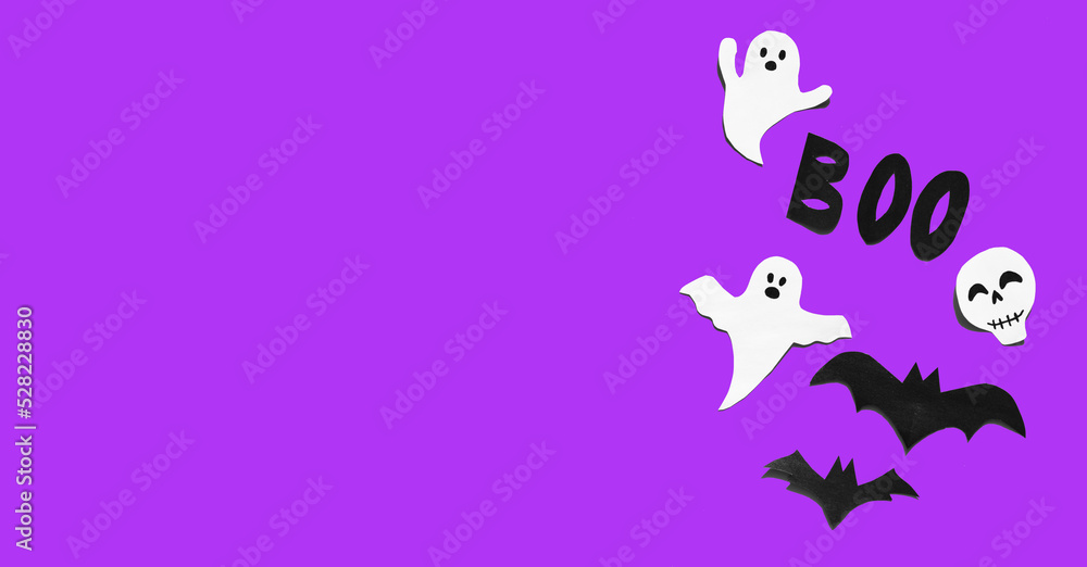 Fototapeta premium Halloween set decorations with ghost, bat, skeleton and word BOO on violet very peri background. Holiday party, minimal greeting card, spooky concept. flat lay, copy space, top view, place for text