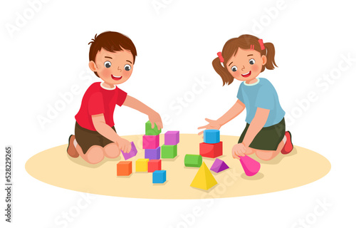 cute little kids boy and girl playing with building blocks educational toys together on the floor