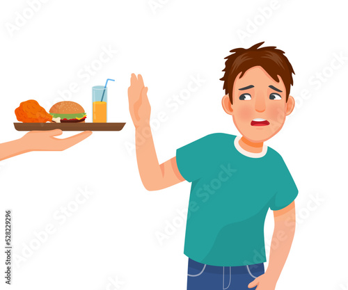 Young man on diet refusing to eat junk food like fried chicken and burger