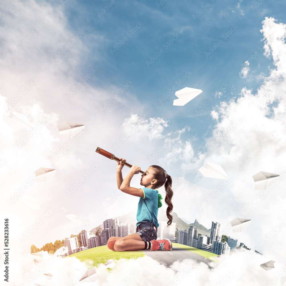 Concept of careless happy childhood with girl looking in future