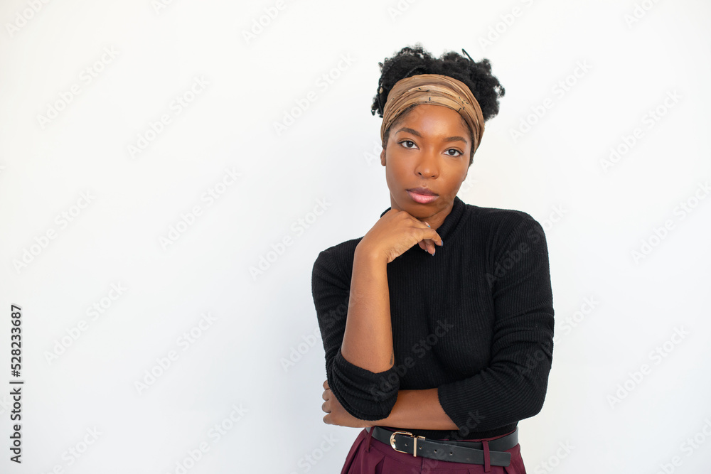 Portrait of African American woman. Female model in black long sleeve shirt and trousers standing against white background, posing. Portrait, beauty, studio photoshoot concept Portrait of African American woman. Female model in black long sleeve shirt and trousers standing against white background, posing. Portrait, beauty, studio photoshoot concept