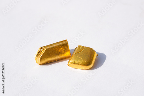 Pieces of Pure Gold Biscuit on isolated white background. Gold nuggets.