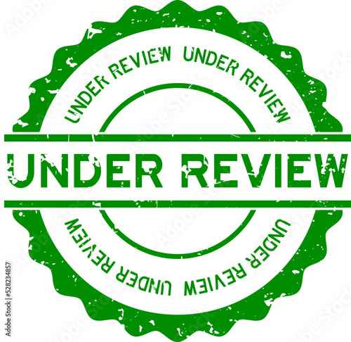 Grunge green under review word round rubber seal stamp on white background