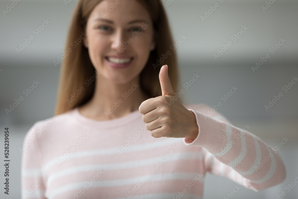 Happy satisfied customer woman showing thumb up at camera, making like hand, recommending good quality of product, store, service. Client satisfaction, feedback. Close up Happy satisfied customer woman showing thumb up at camera, making like hand, recommending good quality of product, store, service. Client satisfaction, feedback. Close up