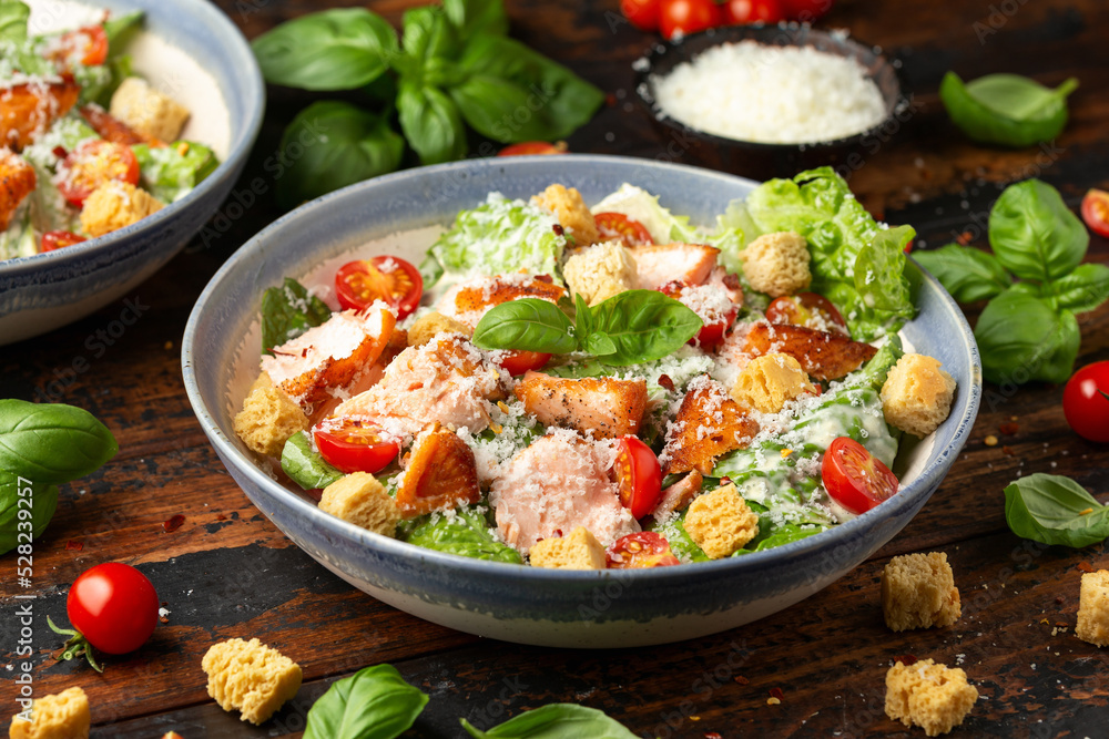 Salmon Caesar salad with grilled fish, croutons and cherry tomatoes Salmon Caesar salad with grilled fish, croutons and cherry tomatoes