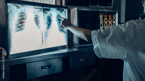 Bild auf Leinwand Medicine doctor working with a patients x-ray scans digital healthcare and connection