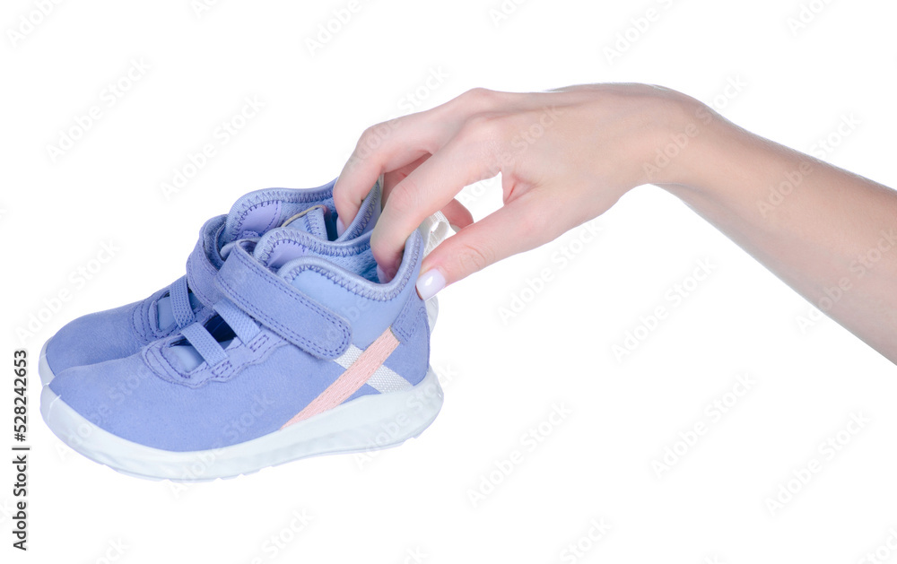 Children's blue shoes in hand on white background isolation