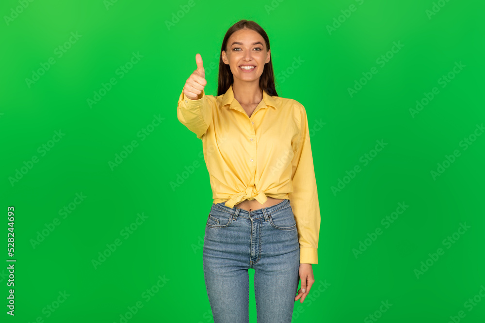 Smiling Lady Gesturing Thumbs Up Standing Over Green Background Smiling Lady Gesturing Thumbs Up Standing Over Green Background