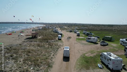 Aerial view of a camper van entering the kitesurfing beach.