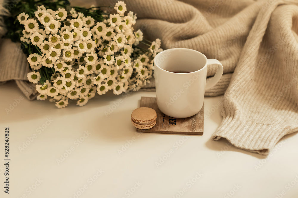 Morning coffee. A cup of coffee on a wooden table and an open book against a background of a bouquet of spring flowers. Still life concept. Cozy morning. Morning coffee. A cup of coffee on a wooden table and an open book against a background of a bouquet of spring flowers. Still life concept. Cozy morning.