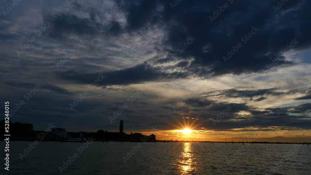 VENICE, ITALY - JULY 7, 2018: view from the sea . sunset over the water surface, near the islands of Venice. Burano, Murano, San Michele, San Giorgio Maggiore, San Servolo Island, St. George, Torcello