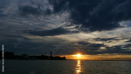VENICE  ITALY - JULY 7  2018  view from the sea . sunset over the water surface  near the islands of Venice. Burano  Murano  San Michele  San Giorgio Maggiore  San Servolo Island  St. George  Torcello