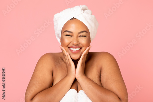 Happy Overweight African American Woman Touching Face On Pink Background