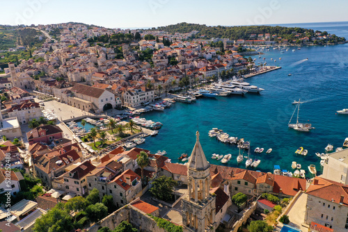 Croatian Island Hvar Harbor in Summertime with multiple moored Yachts and boats.