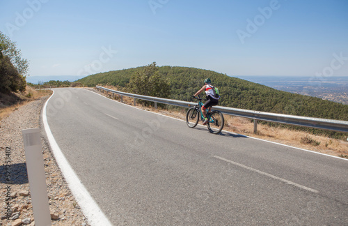 Senior cyclist speeding down winding road
