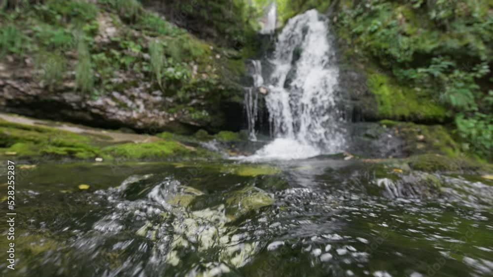 Bubbling stream with mountain fresh water and waterfalls in the forest. Fast river with stones Bubbling stream with mountain fresh water and waterfalls in the forest. Fast river with stones