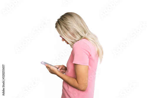 Profile of a young blonde woman in a pink t-shirt looking at the mobile phone screen isolated on a white background. Incorrect back position