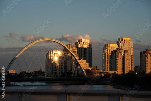 Nursultan, Kazakhstan, August 2022. View of the bridge on the embankment of the Yesil River at sunset. High quality photo