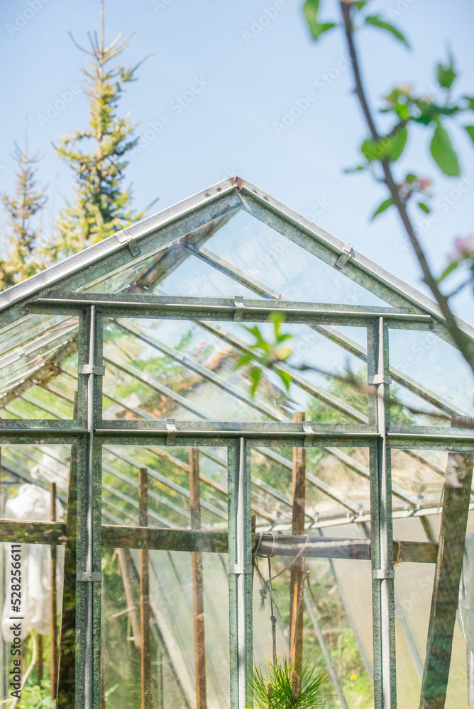 Little greenhouse in rural area. Small village glasshouse for food.