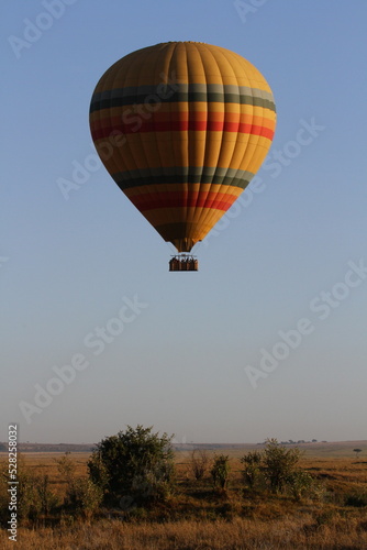 Hot air baloon flying above savannah planes in Maasai Mara Kenya © Alla Tsytovich