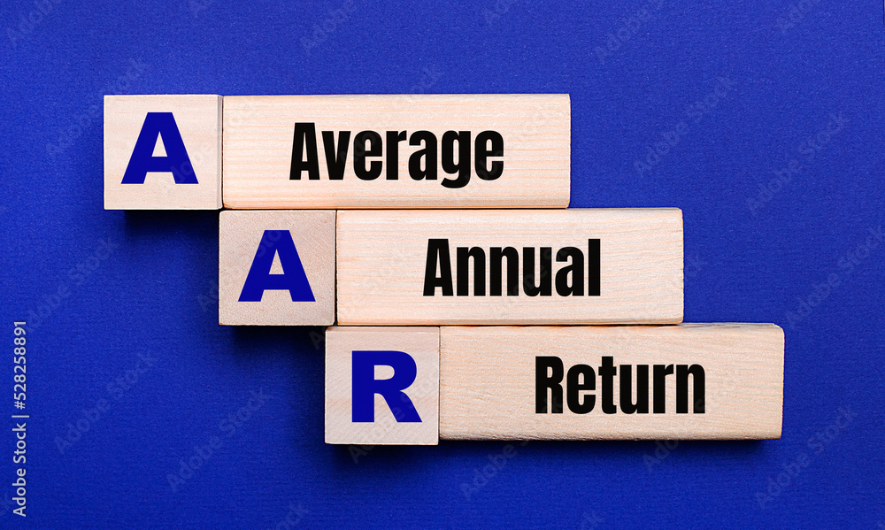 On a bright blue background, light wooden blocks and cubes with the text AAR Average Annual Return On a bright blue background, light wooden blocks and cubes with the text AAR Average Annual Return