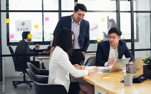 Group of business asian and caucasian people wearing formal suits, talking, meeting and discussing their projects at office. Working and Teamwork Concept.