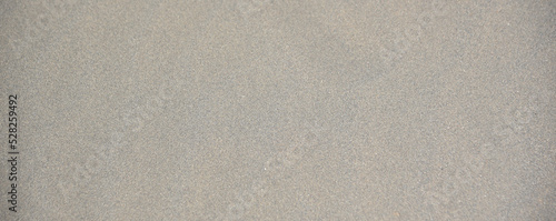 Gray textured background of river and sea sand as in the desert