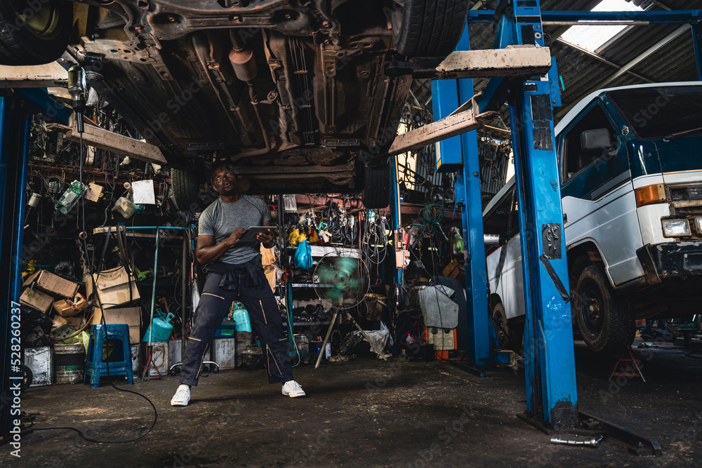 Fototapeta premium Car suspension specialists are carefully examining the broken car.