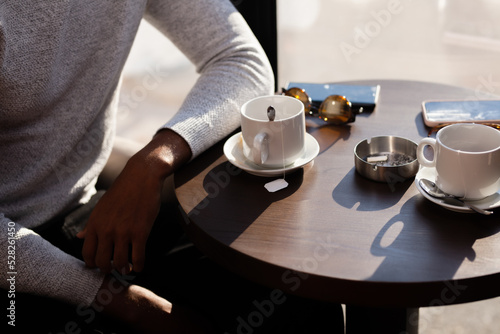 Friends in a restaurant talking smiling and drinking tea. Business colleagues having a meeting after work at a cafe bar. Abstract photo..