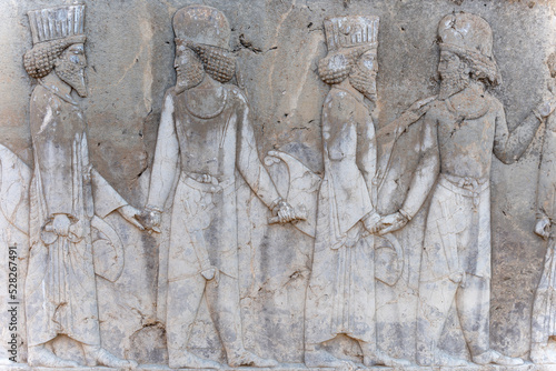 Bas-relief decoration along stairs from Darius palace to Palace of Xerxes. Ancient ruins of Persepolis near Shiraz in southern Iran. This UNESCO World Heritage Site showcases beautiful ruins from the 