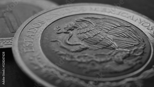 Coin of 5 Mexican pesos close-up. Peso of Mexico. Reverse of coin with coat of arms of country. Eagle and snake. Black and white money wallpaper. News about economy or business. Loan and credit. Macro