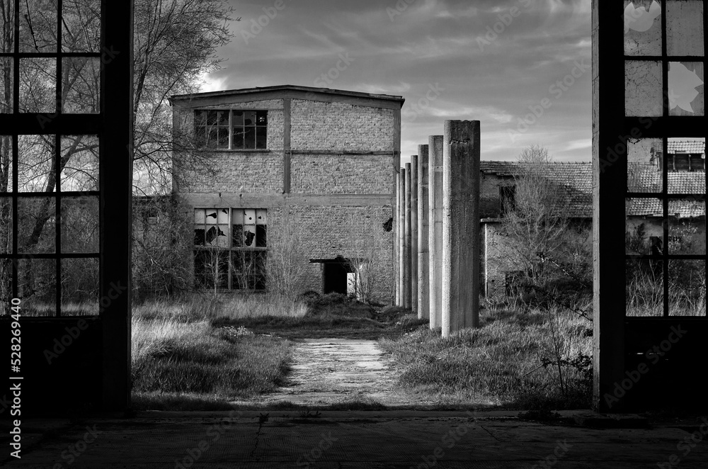 Old abandoned factory building or warehouse on a sunny summer day Old abandoned factory building or warehouse on a sunny summer day
