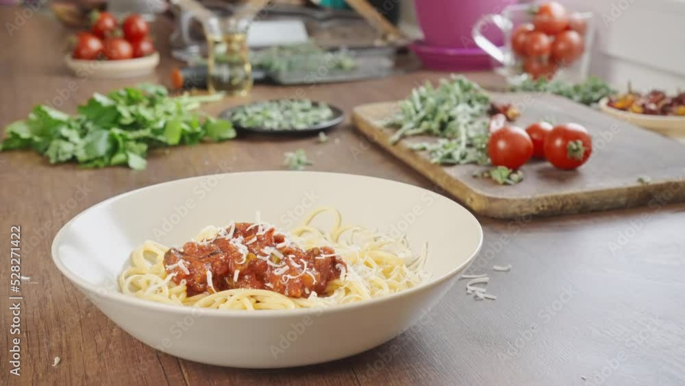 grated cheese fall on the plate spaghetti with marinara or tomato sauce italian dinner at home slow motion shot grated cheese fall on the plate spaghetti with marinara or tomato sauce italian dinner at home slow motion shot