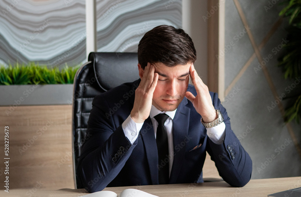 portrait of young businessman in a dark blue suit working in the office portrait of young businessman in a dark blue suit working in the office