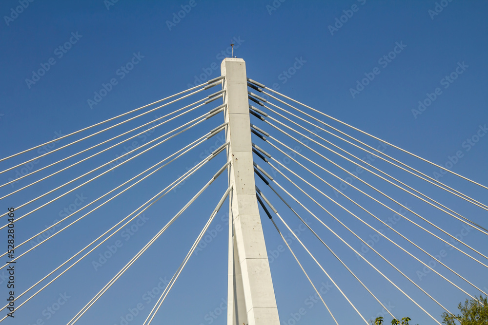 Metal strings of an architectural bridge against a blue sky Metal strings of an architectural bridge against a blue sky