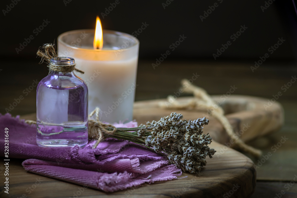 Glass bottle Lavender essential oil dried seed aromatherapy spa massage concept. herb Purple candle wood table background sea salt still life rustic cutting board napkin Glass bottle Lavender essential oil dried seed aromatherapy spa massage concept. herb Purple candle wood table background sea salt still life rustic cutting board napkin
