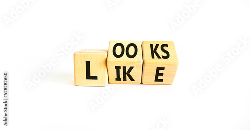 Looks like symbol. Concept words Looks like on wooden cubes. Beautiful white table white background. Business, popular quotes and looks like concept. Copy space.