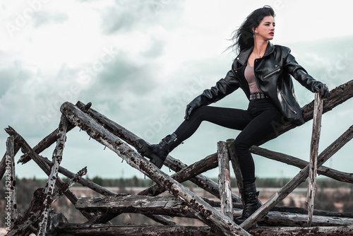 Fototapeta Woman sitting on a broken wooden construction